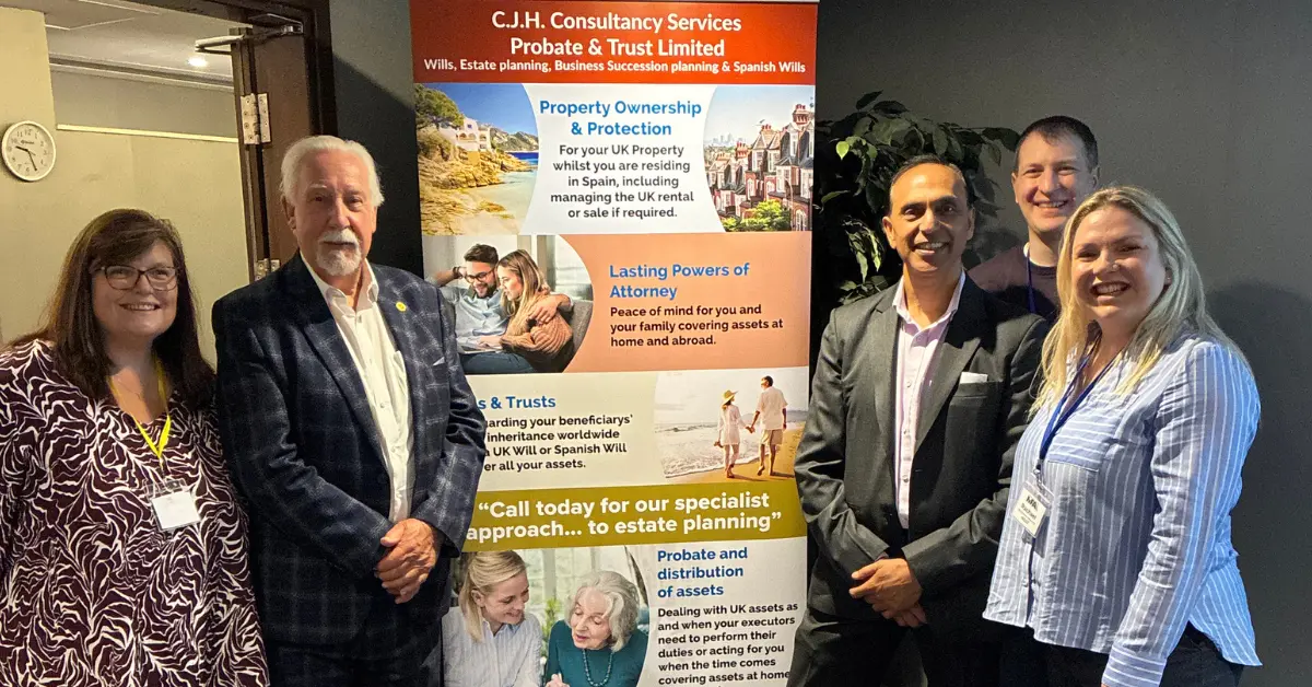 Guest speaker and attendees at the April 2026 Crawley Property Meet beside the CJH Consultancy Services estate planning display.